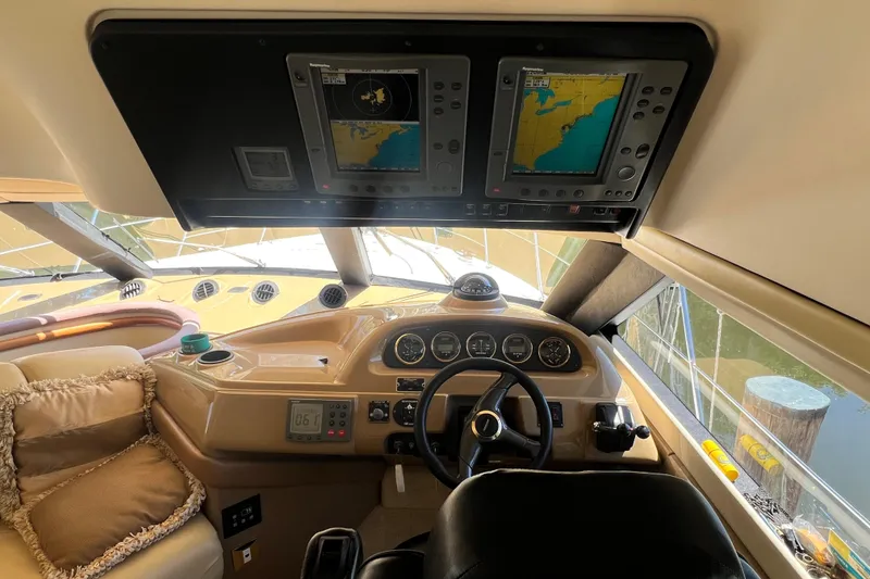 Slide: The Image of Interior view of 2003 Carver 450 Voyager Pilothouse helm with navigation screens. - 23