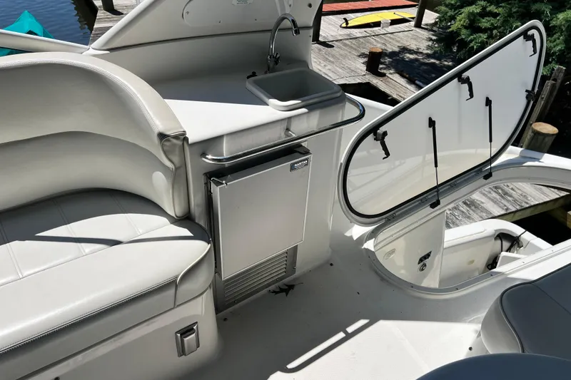Slide: The Image of 2003 Carver 450 Voyager Pilothouse interior with sink, seating, and open hatch. - 44