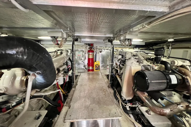 Slide: The Image of Engine room of a 2003 Carver 450 Voyager Pilothouse with visible machinery and fire extinguisher. - 49