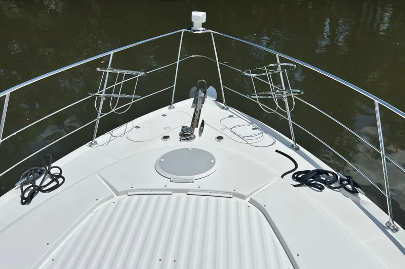 Slide: The Image of Bow view of 2003 Carver 450 Voyager Pilothouse yacht with railing and anchor. - 56