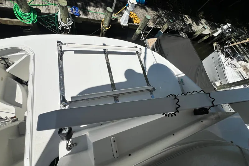 Slide: The Image of 2003 Carver 450 Voyager Pilothouse deck with docked boats and coiled ropes. - 48