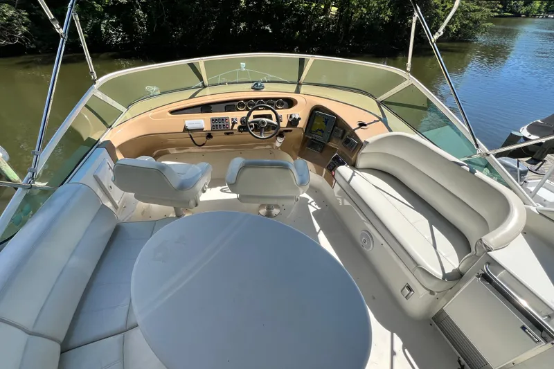 Slide: The Image of 2003 Carver 450 Voyager Pilothouse helm with seating, steering wheel, and navigation equipment. - 42