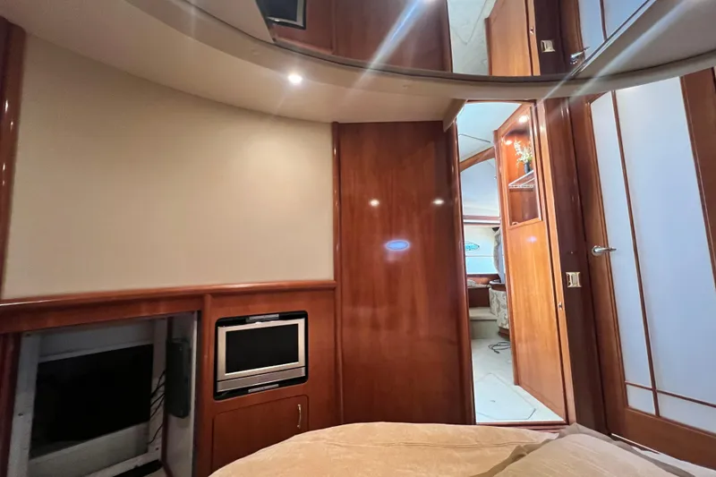 Slide: The Image of Interior of 2003 Carver 450 Voyager Pilothouse with wood paneling and built-in TV. - 29