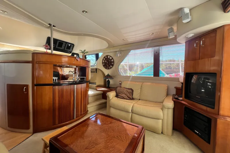 Slide: The Image of Luxurious interior of 2003 Carver 450 Voyager Pilothouse with elegant wood finishes and cozy seating. - 11