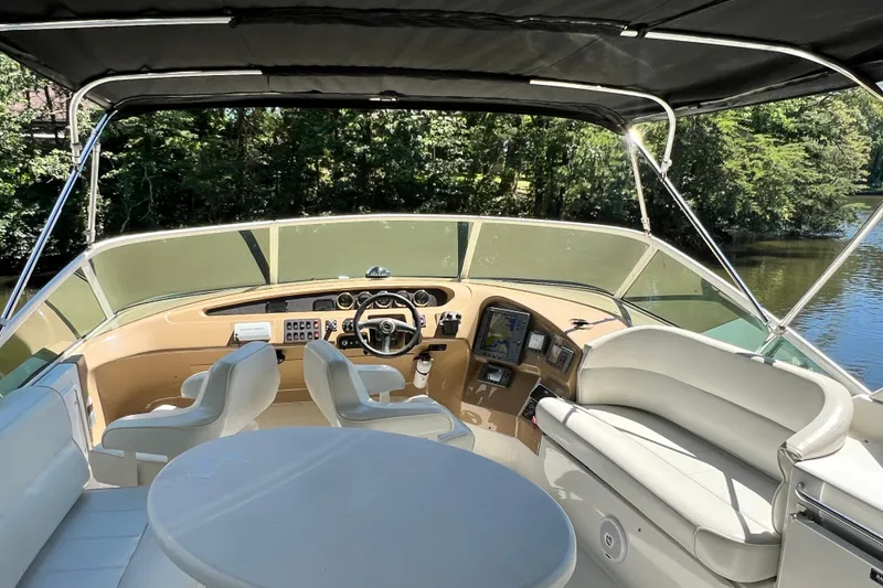 Slide: The Image of 2003 Carver 450 Voyager Pilothouse helm with seating, steering wheel, and navigation equipment. - 39
