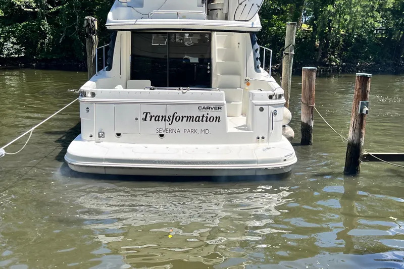 Slide: The Image of 2003 Carver 450 Voyager Pilothouse docked, rear view, named "Transformation," Severna Park, MD. - 5