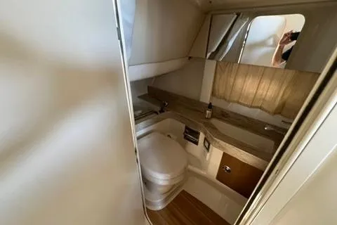 Slide: The Image of 2016 Formula 350 Crossover Bowrider I/O bathroom interior with modern fixtures and wood accents. - 22