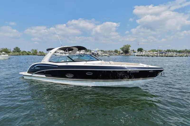 Slide: The Image of 2016 Formula 350 Crossover Bowrider I/O on calm water under blue sky. - 7