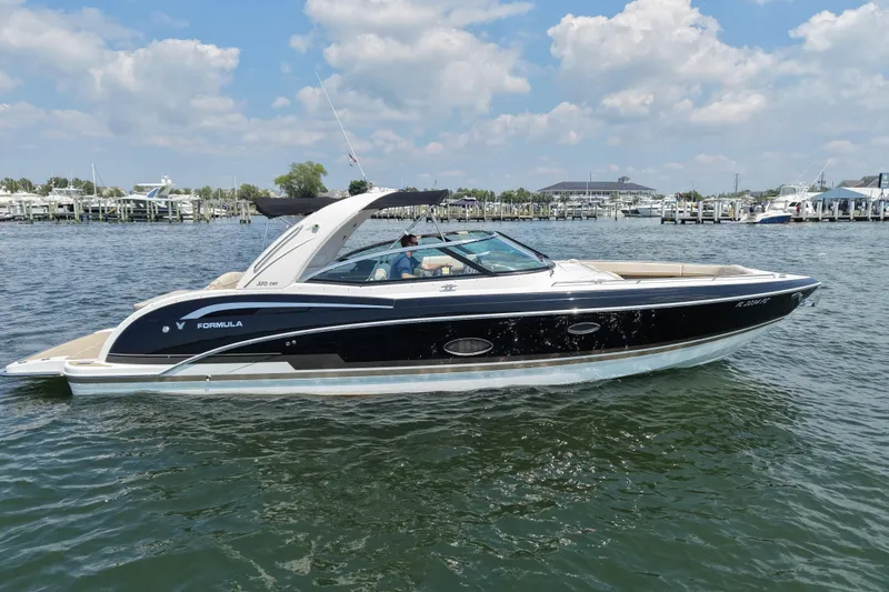 Slide: The Image of 2016 Formula 350 Crossover Bowrider I/O on water, sunny day, marina background. - 6