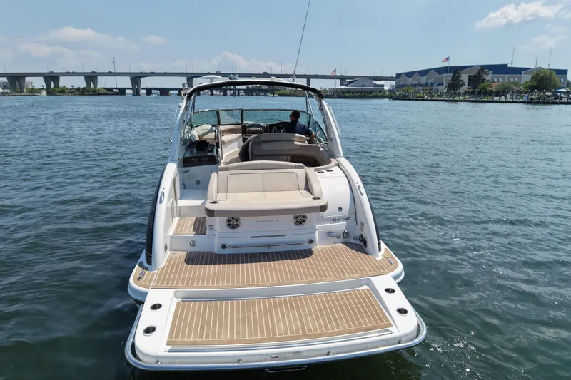 Slide: The Image of 2016 Formula 350 Crossover Bowrider I/O on water, showcasing spacious deck and elegant design. - 3