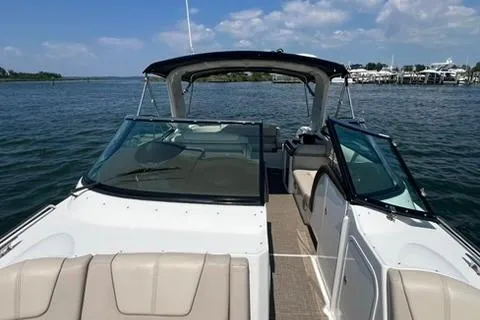 Slide: The Image of 2016 Formula 350 Crossover Bowrider I/O on calm water, showcasing sleek design and spacious seating. - 11