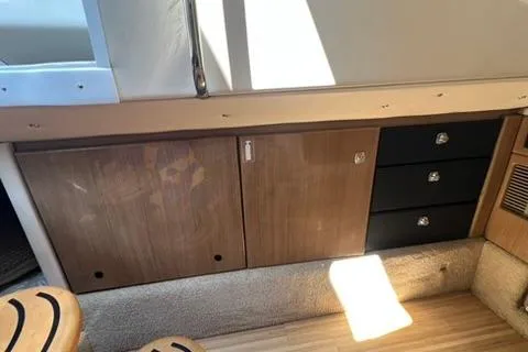 Slide: The Image of 2016 Formula 350 Crossover Bowrider I/O interior cabinetry with wood finish and storage drawers. - 21