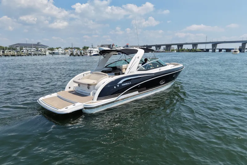 Slide: The Image of 2016 Formula 350 Crossover Bowrider I/O cruising on a sunny day near a marina. - 5