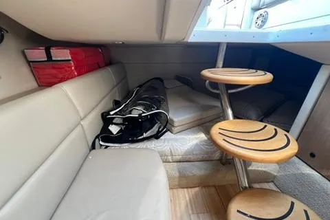 Slide: The Image of 2016 Formula 350 Crossover Bowrider I/O cabin interior with seating and wooden steps. - 24