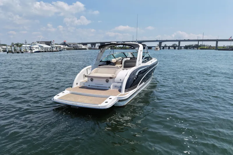 Slide: The Image of 2016 Formula 350 Crossover Bowrider I/O on water near marina and bridge. - 4