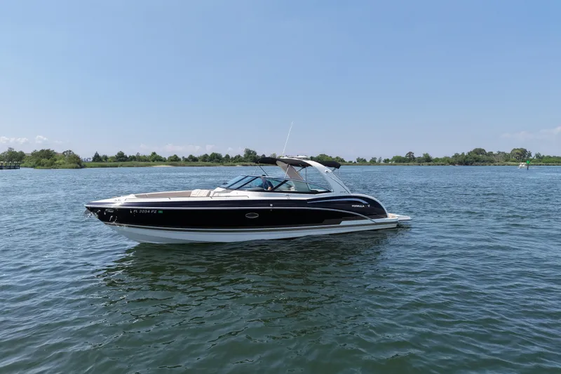 Slide: The Image of 2016 Formula 350 Crossover Bowrider I/O on calm water, clear sky background. - 2