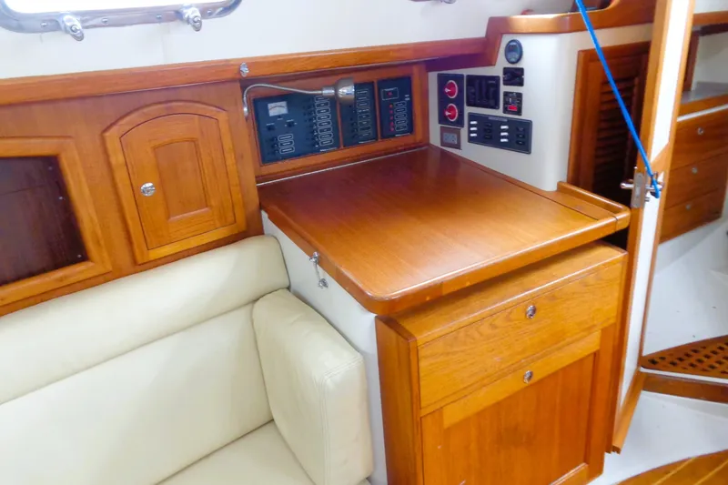 Slide: The Image of Interior of 2008 Pacific Seacraft 31 sailboat with wooden cabinetry and navigation station. - 5