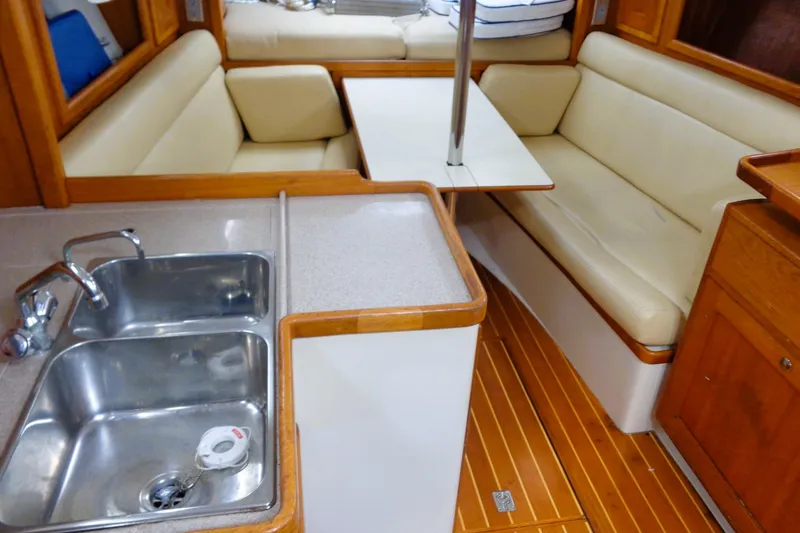Slide: The Image of Interior of 2008 Pacific Seacraft 31 sailboat with kitchen sink and dining area. - 3