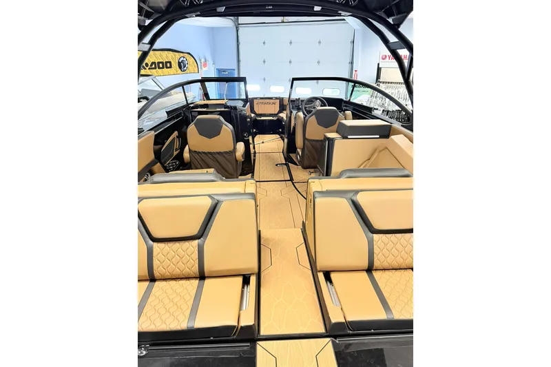 Slide: The Image of Interior view of 2026 Yamaha Boats 255XD, featuring luxurious tan and black seating. - 2