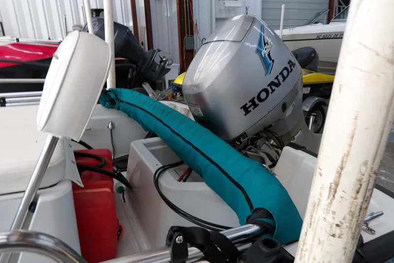 Slide: The Image of 1997 Boston Whaler Dauntless 13 with Honda outboard motor in storage. - 14