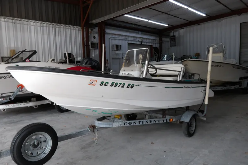 Slide: The Image of 1997 Boston Whaler Dauntless 13 boat on trailer in storage facility. - 2