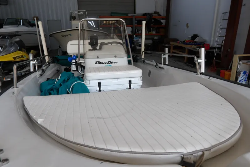 Slide: The Image of 1997 Boston Whaler Dauntless 13 boat in storage, featuring white seating and console. - 7