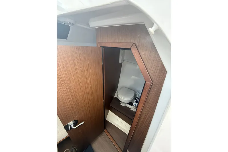 Slide: The Image of Interior cabin view of 2020 Jeanneau Leader 7.5 CC, featuring a compact marine toilet. - 16