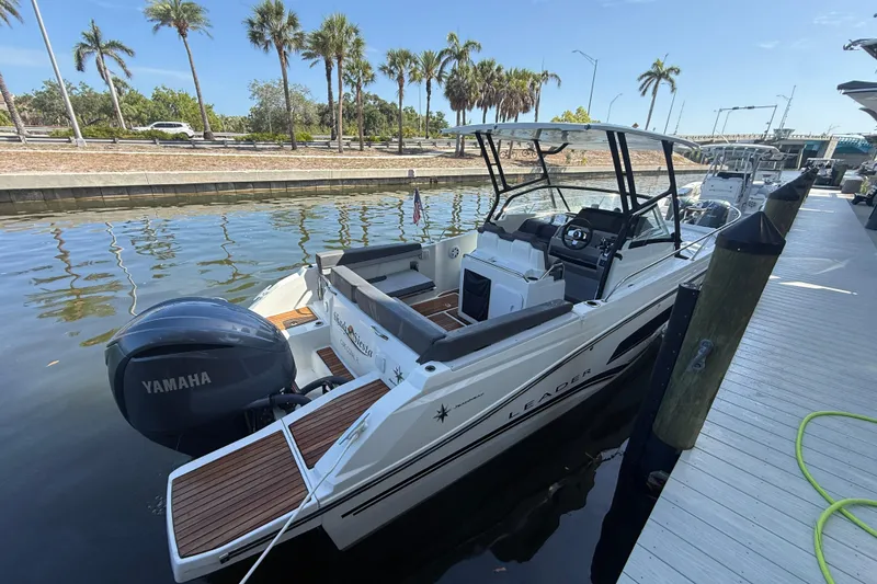 Slide: The Image of 2020 Jeanneau Leader 7.5 CC boat docked, featuring Yamaha engine, palm trees in background. - 31