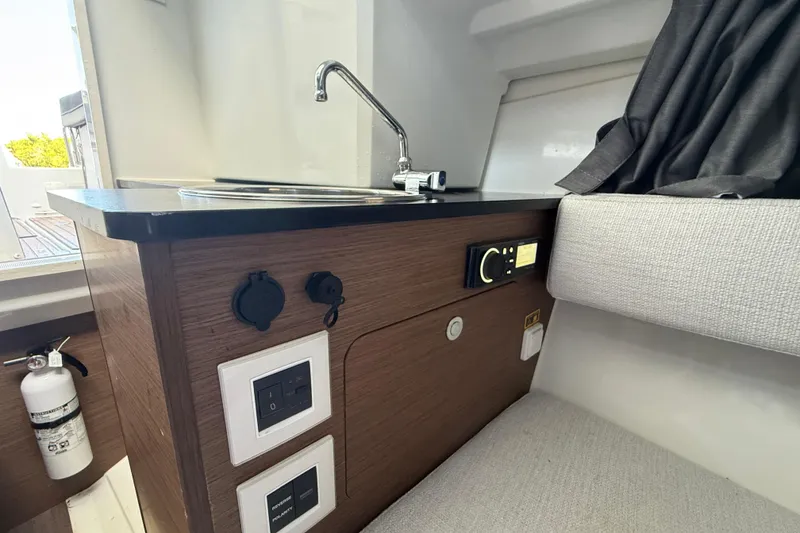 Slide: The Image of Interior view of 2020 Jeanneau Leader 7.5 CC boat, featuring a compact kitchenette. - 14