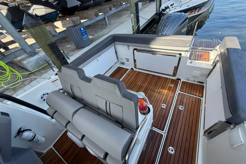 Slide: The Image of 2020 Jeanneau Leader 7.5 CC boat interior with teak flooring and seating. - 34