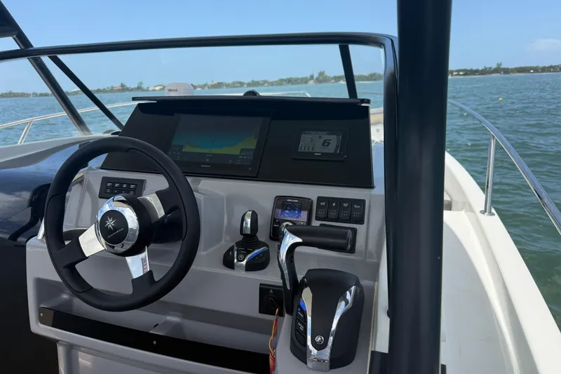 Slide: The Image of Cockpit view of 2020 Jeanneau Leader 7.5 CC boat with steering wheel and controls. - 17