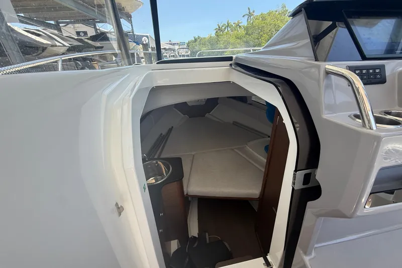 Slide: The Image of 2020 Jeanneau Leader 7.5 CC cabin interior with seating and storage. - 12