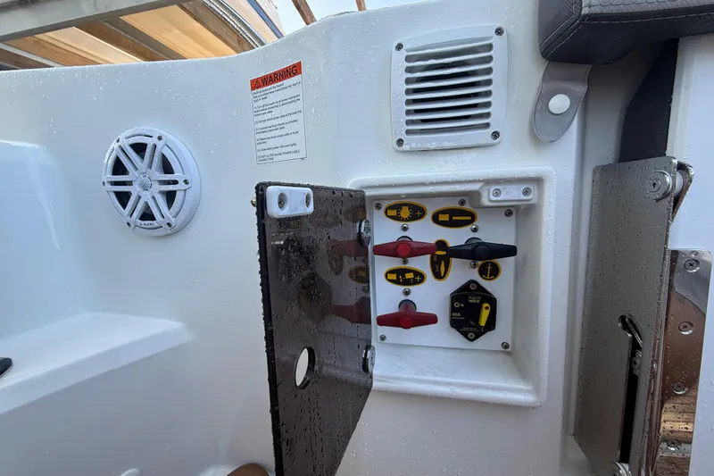 Slide: The Image of Control panel on a 2020 Jeanneau Leader 7.5 CC boat, featuring switches and speaker. - 27