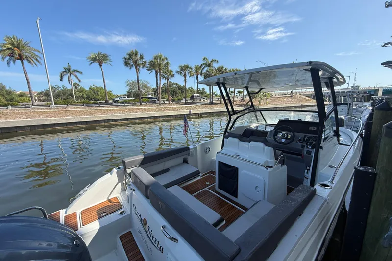 Slide: The Image of 2020 Jeanneau Leader 7.5 CC boat docked by palm trees, sunny day. - 4