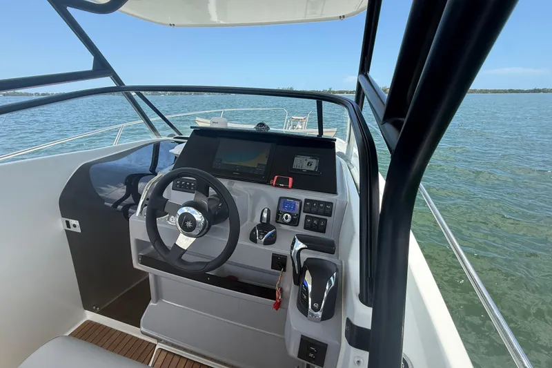 Slide: The Image of 2020 Jeanneau Leader 7.5 CC helm with modern controls on open water. - 18