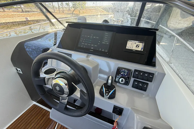 Slide: The Image of Cockpit of 2020 Jeanneau Leader 7.5 CC with modern navigation controls and steering wheel. - 10