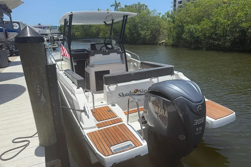 Slide: The Image of 2020 Jeanneau Leader 7.5 CC boat docked, featuring Yamaha 300 V6 engine. - 2