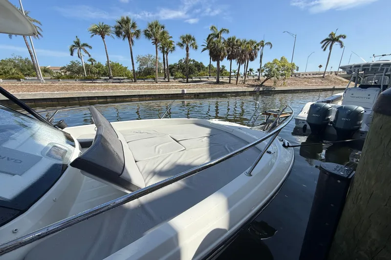 Slide: The Image of 2020 Jeanneau Leader 7.5 CC boat docked by palm trees under clear blue sky. - 30