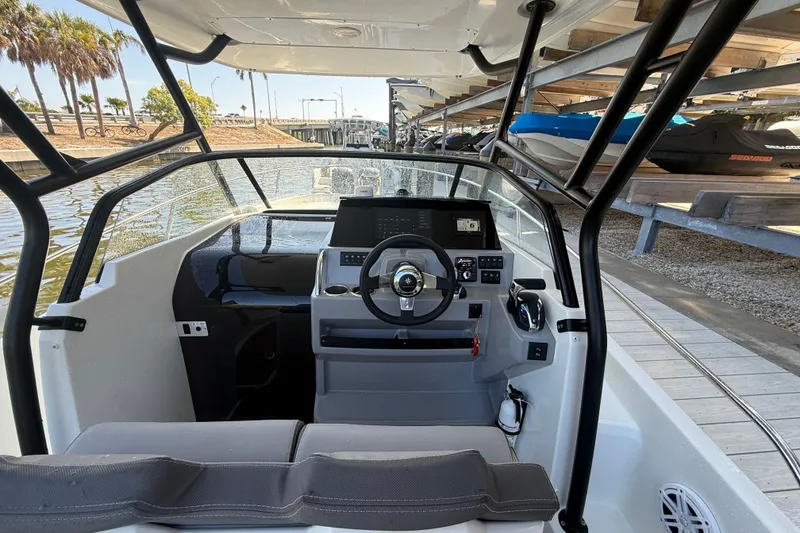 Slide: The Image of 2020 Jeanneau Leader 7.5 CC boat cockpit with steering wheel and dashboard controls. - 6