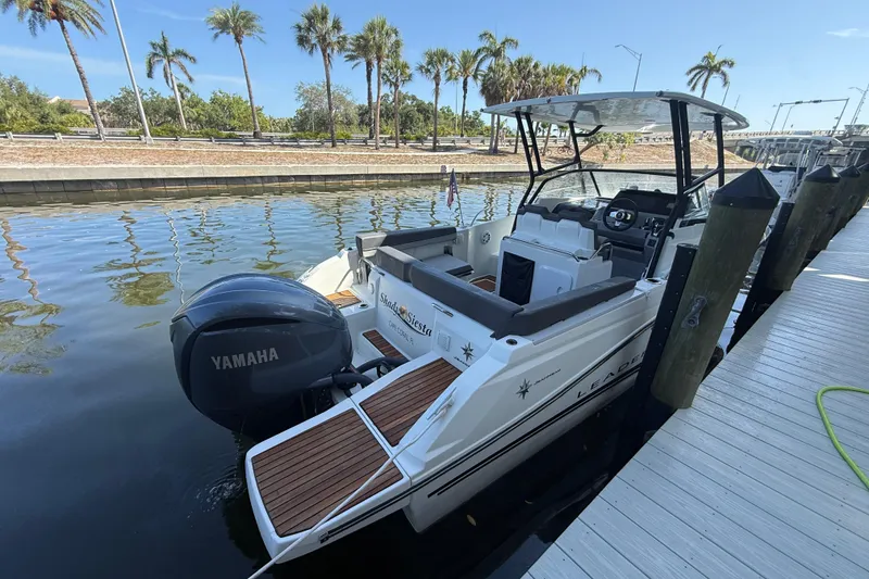 Slide: The Image of 2020 Jeanneau Leader 7.5 CC boat docked, featuring Yamaha outboard motor, palm trees in background. - 39