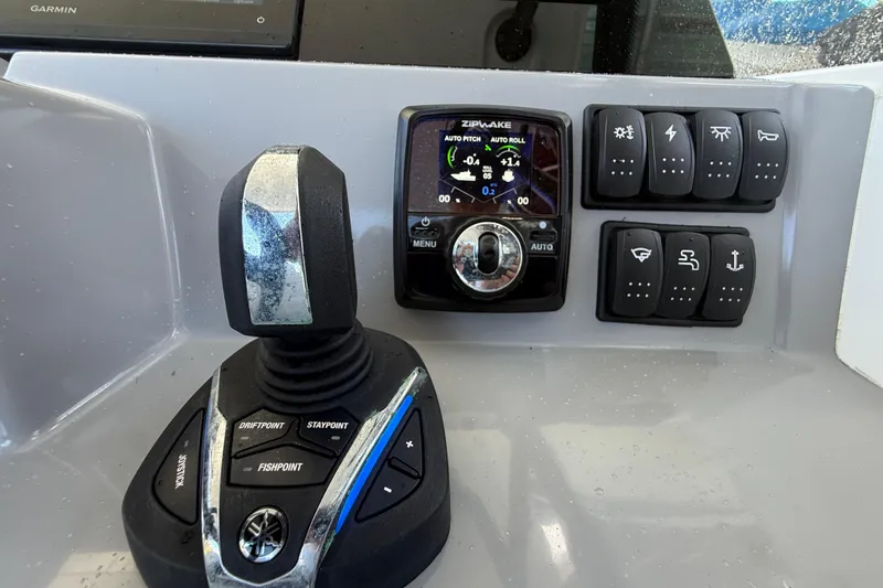 Slide: The Image of Control panel of a 2020 Jeanneau Leader 7.5 CC boat with joystick and switches. - 8