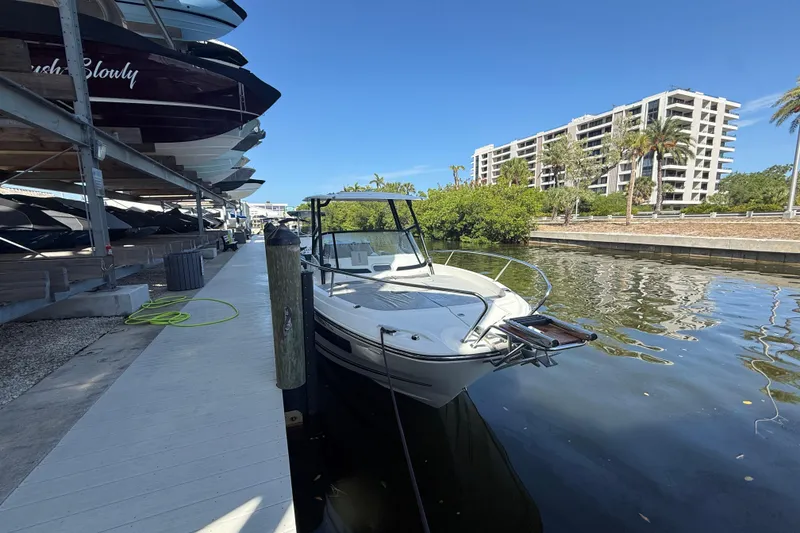 Slide: The Image of 2020 Jeanneau Leader 7.5 CC docked near waterfront buildings and greenery. - 36