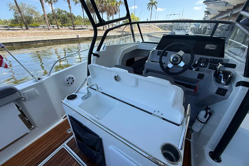 Slide: The Image of Interior view of 2020 Jeanneau Leader 7.5 CC boat with steering wheel and sink. - 7