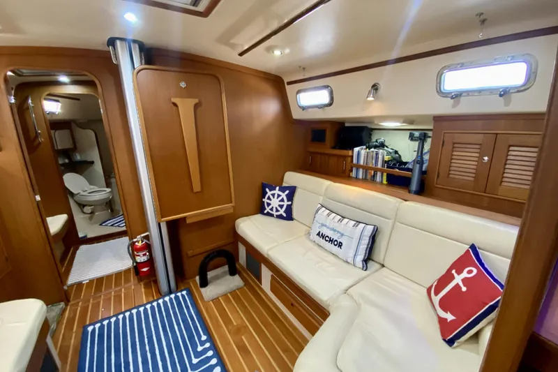 Slide: The Image of Luxurious 2006 Island Packet 440 yacht interior with nautical-themed decor and cozy seating area. - 44