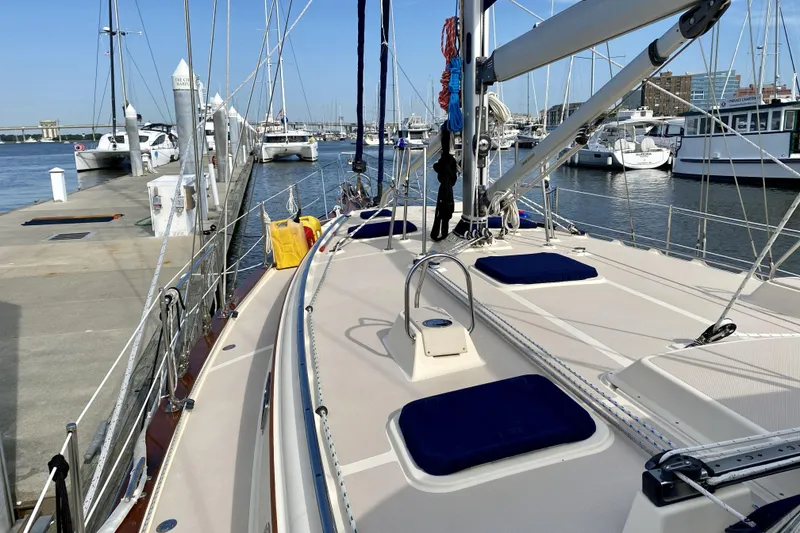 Slide: The Image of Island Packet 440 sailboat docked at marina, showcasing deck and rigging, 2006 model. - 8