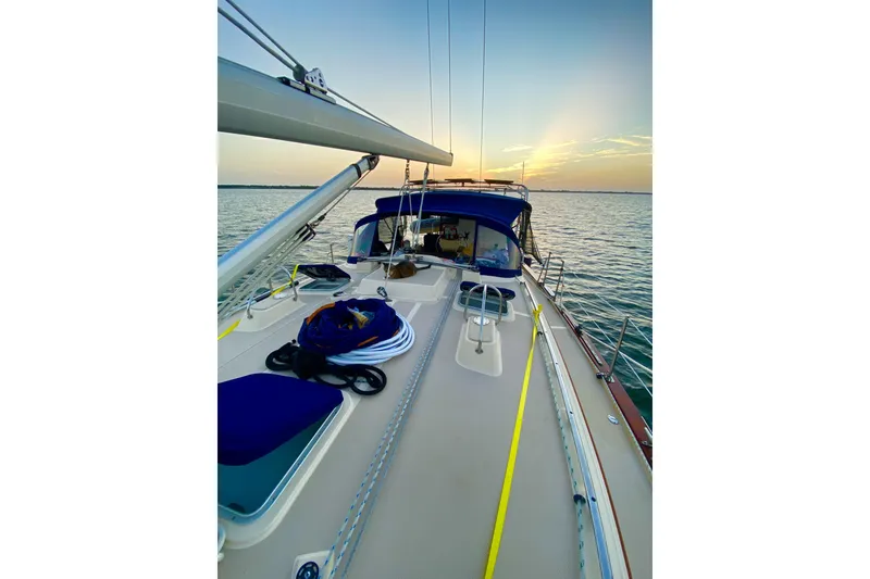 Slide: The Image of Sailing yacht Island Packet 440, 2006 model, at sunset on calm waters. - 18