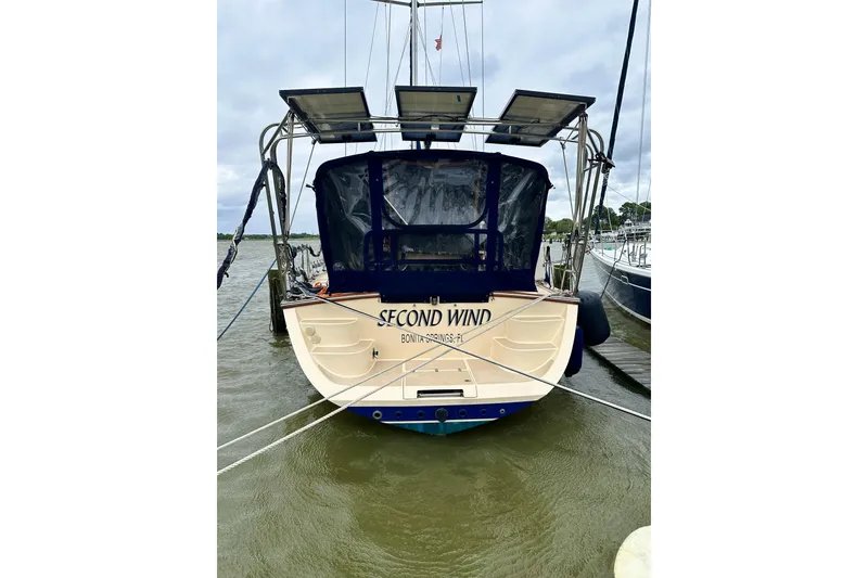 Slide: The Image of 2006 Island Packet 440 sailboat "Second Wind" docked with solar panels visible. - 13