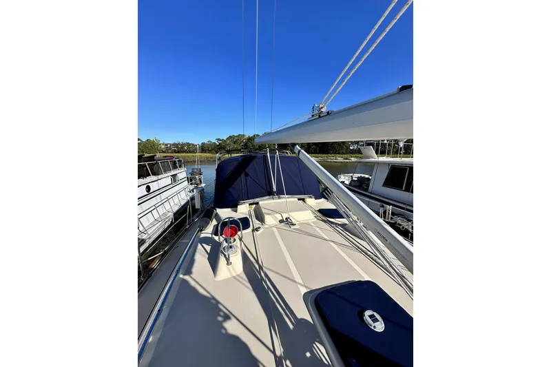 Slide: The Image of 2006 Island Packet 440 sailboat deck with clear blue sky and marina view. - 21