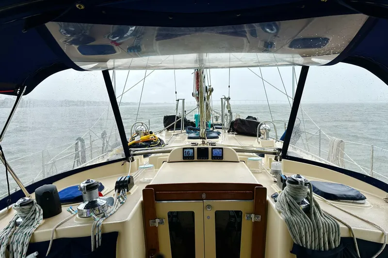 Slide: The Image of Cockpit view of 2006 Island Packet 440 sailboat on a rainy day at sea. - 28