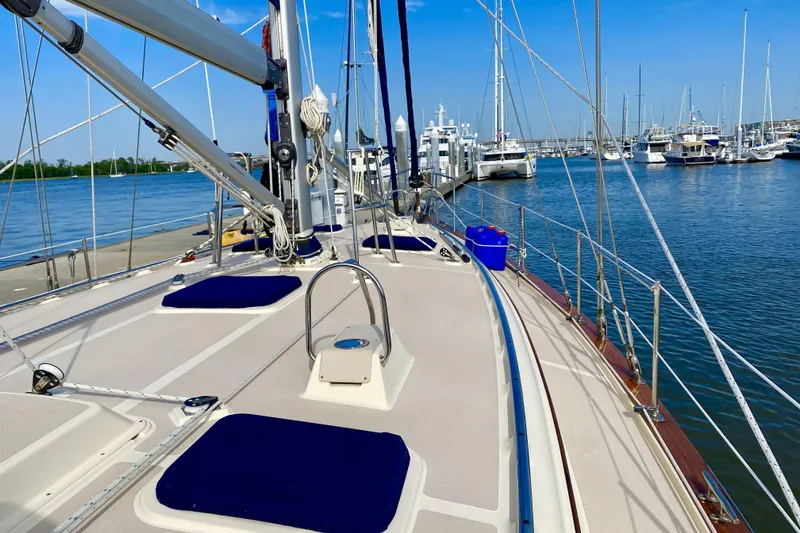 Slide: The Image of 2006 Island Packet 440 sailboat docked at marina, showcasing deck and rigging. - 9